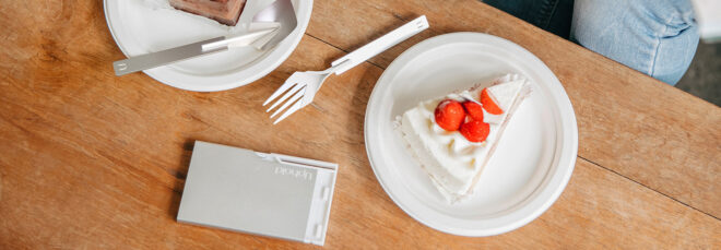 A fork in between two plates of cake