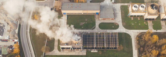 An aerial view of a factory producing smoke