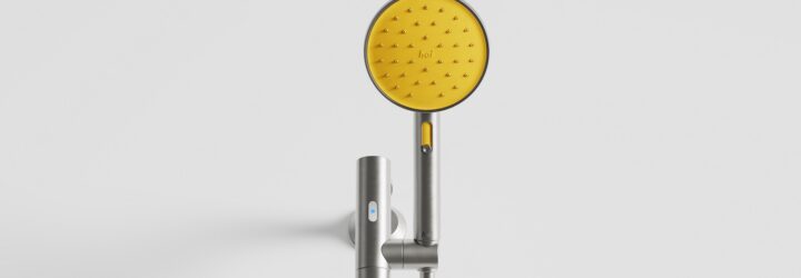 A yellow showerhead attached to a white wall