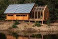 An extended, modular cabin beside a river
