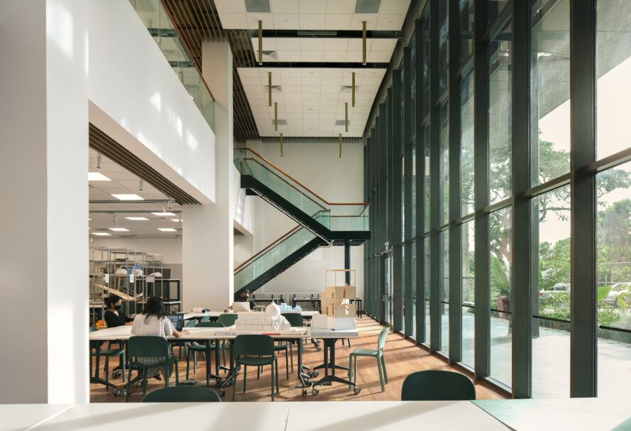 An inner desk and study area against a wall of windows