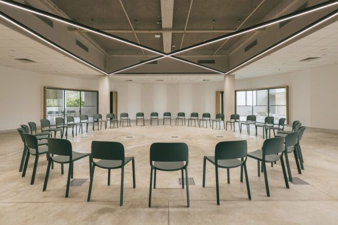 Black chairs formed in a circle in a room