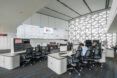 An office space with chairs facing a front monitor projection