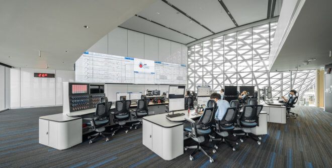 An office space with chairs facing a front monitor projection