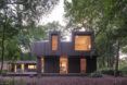 A two-story home hidden in a forest