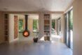 An interior living space with shelves along the walls and a hanging fireplace