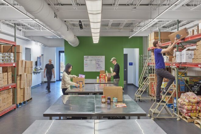 Four people working in a food pantry
