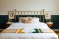 A white bed with a metal frame