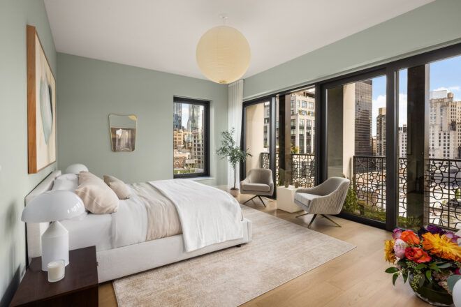 A bedroom with a wall of windows to overlook the view outdoors