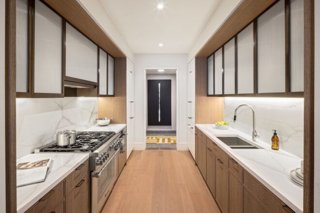 Two cupboards lining on either side of a kitchen