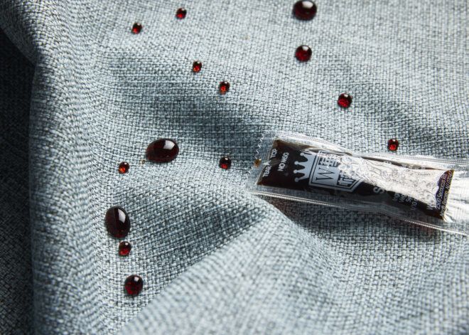 A blue fabric with beads of soy sauce from a soy sauce packet