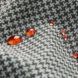 A houndstooth pattern cloth with beads of red liquid