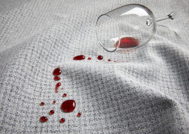 A wine glass spilled over a gray fabric