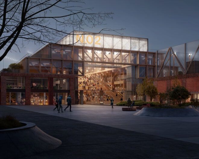 A school lit up in the evening with a glass exterior