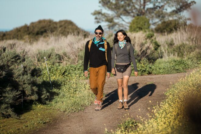 Two people hiking through a trail