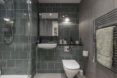Modern bathroom with dark grey-green tiling