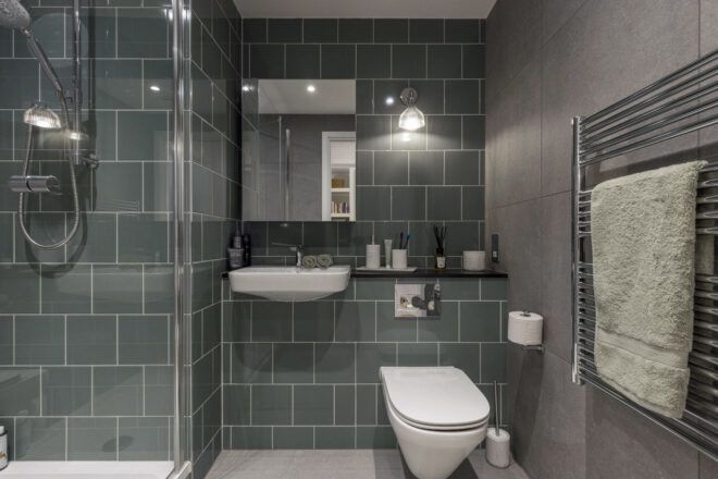 Modern bathroom with dark grey-green tiling