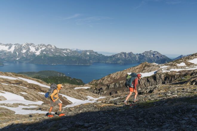 Two backpackers on the side of a mountain
