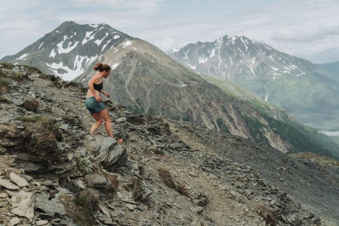 A woman climbing down a mountain