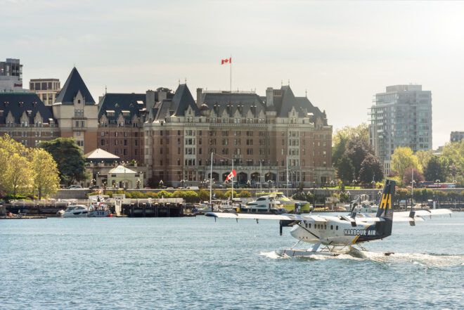 A landscape of a oceanfront with a large Victorian style building