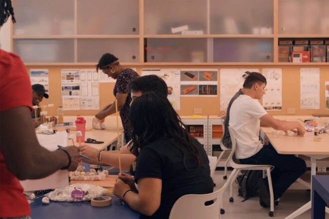 Students working on activities on three classroom tables