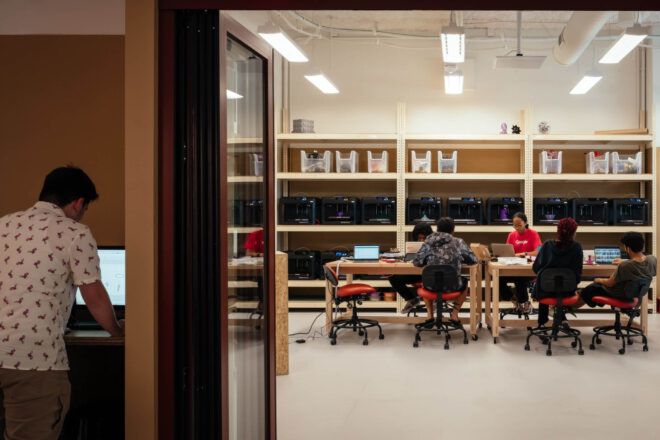 View into a classroom workspace where five students are seated at a table