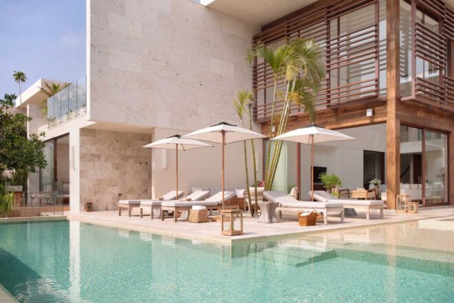 A deck area poolside next to a building
