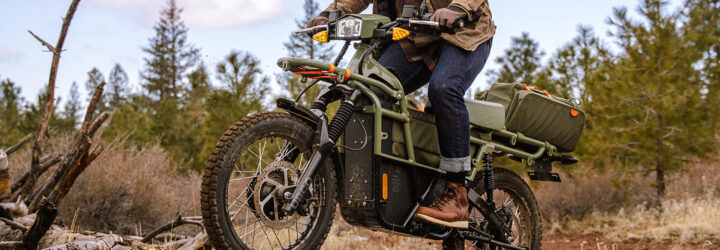 The bottom half of a person riding on an electric bike