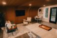 An interior living room with wooden walls