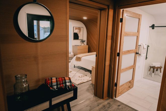 A hallway that opens into the bathroom and the bedroom