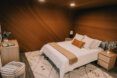 A bedroom with wooden walls