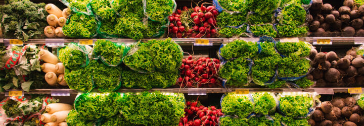 Three rows of produce, including lettuce, carrots and radish
