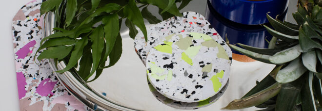 Two coasters on a silver tray over a mat