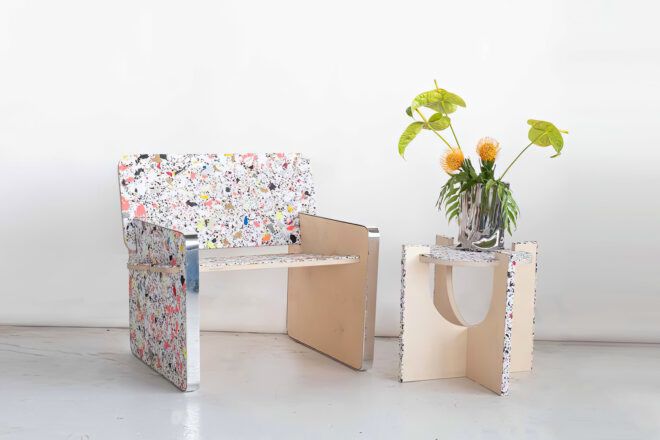 A chair with a table with a plant