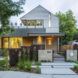 Front facade of the Fargo house with a front porch and an open terrace area on the top level