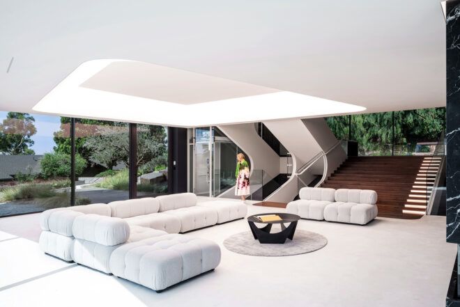 A living room space with white sofas