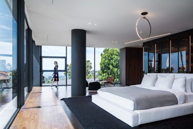 A bedroom with windows surrounding it