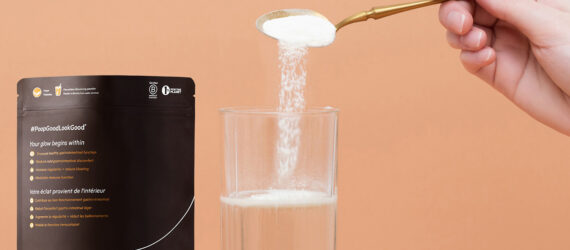 A spoon pouring a white powder into a glass of water