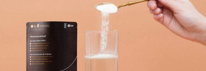 A spoon pouring a white powder into a glass of water