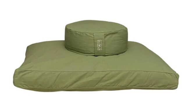 A circular green cushion on top of a square cushion