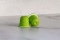 Two green coffee pods