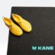 Yellow shoes with holes on a black mat
