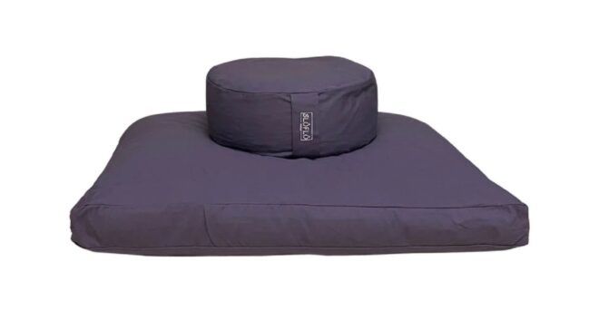 A purple circular cushion on top of a square cushion
