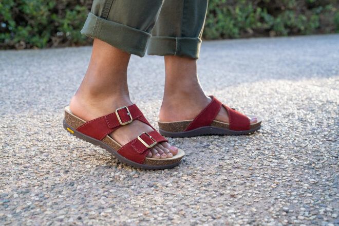 Two feet wearing maroon leather scandals