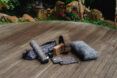 A variety of gray yoga and fitness products on a wooden deck