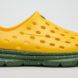 A yellow slip-on shoes with green sole