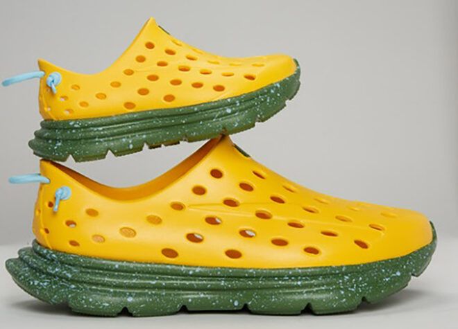 Two yellow shoes with holes and green insoles
