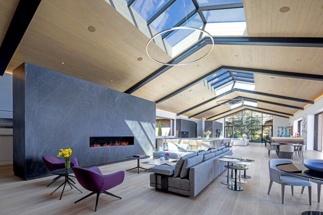 An expansive living room with panels of exposed ceiling