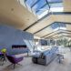 An expansive living room with panels of exposed ceiling