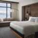 A bedroom with a skyline view